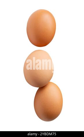Top view set of three fresh brown chicken eggs is isolated on white background with clipping path. Stock Photo
