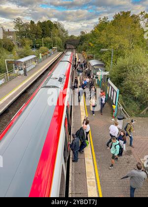 Pontyclun, Wales - 1 October 2024: People getting off and boarding a Transport for Wales Class 197 commuter train stopped at the village station Stock Photo