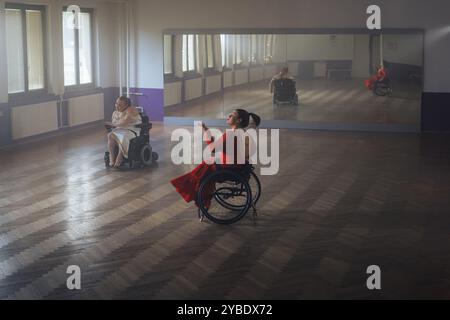 Para dance sport, two determined women with disability enjoy practicing elegant and stylish movements on wheelchair. Stock Photo