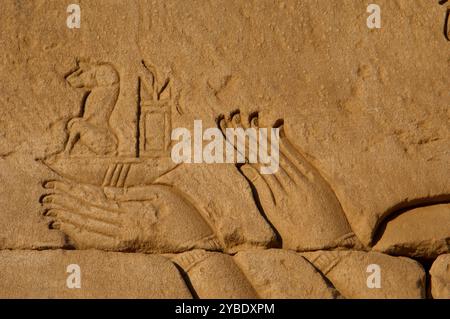 Roman Birth House of Mammisi, Temple complex, Dendera, Egypt, 68-117 AD. Relief showing Emperor Trajan offering a clepsydra - detail of his hands. A water clock or clepsydra is a timepiece by which time is measured by the regulated flow of liquid into or out of a vessel, and where the amount of liquid can then be measured. Water clocks are one of the oldest time-measuring instruments. First Intercolumnar wall - South face. Stock Photo