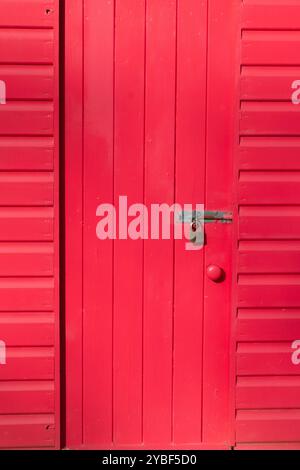 A close-up of a bright red beach hut in Llanbedrog North Wales DSCF9789 Stock Photo