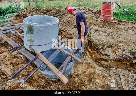 Installing Shoat Rings Install concrete rings of autonomous sewerage system using roller deck ...