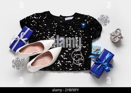 Composition with stylish dress, accessories and Christmas decorations on white background Stock Photo