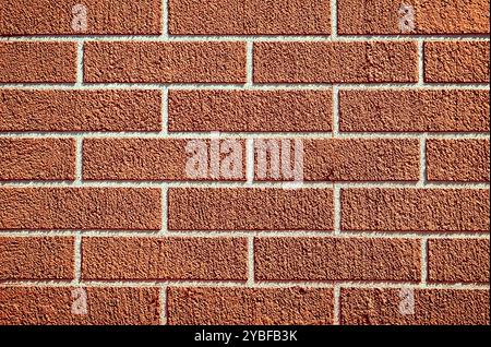 A brick wall is a sturdy structure made of bricks and mortar. It provides privacy, security, and aesthetic appeal to buildings. durability and timeles Stock Photo