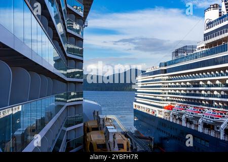 Sitka, Alaska, USA - September 24, 2024: Royal Caribbean’s Ovation of the Seas and Holland America Line’s Nieuw Amsterdam cruise ships docked side by Stock Photo