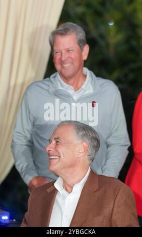 Austin Texas USA, October 18 2024: Texas Governor GREG ABBOTT (front) and Georgia Gov. Brian Kemp share a laugh during a pep rally on the eve of a college football game between the University of Texas and the University of Georgia in Austin. Credit: Bob Daemmrich/Alamy Live News Stock Photo