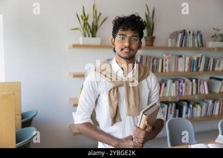 Serious Indian male student in glasses posing for portrait Stock Photo
