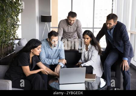 Diverse business team of young project managers working at laptop Stock Photo
