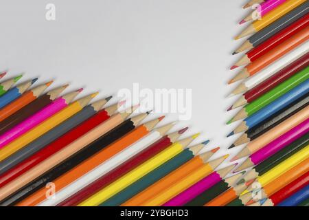 Abstract composition of a set cedar wooden colour pencils against a white background in zipper style Stock Photo