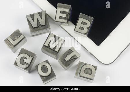 Old lead ink printing type letters from a book printing company, as a collage positioned on a modern tablet Stock Photo