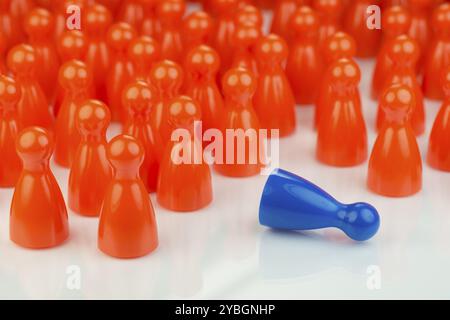 Conceptual orange game pawns and a blue play pawn as abstract display of inequality in color and number of Stock Photo