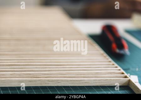 Wood and cutter set for making architecture models on working table. Selective focus Stock Photo