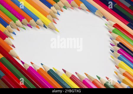 Collection of colorful pencils as a background picture in a heart shape Stock Photo