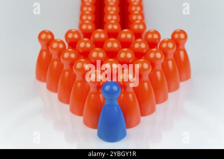 Conceptual orange game pawns and a blue play pawn as abstract display of inequality in color and number of Stock Photo