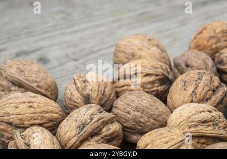 Walnuts on an aged wooden plank as a background photo Stock Photo