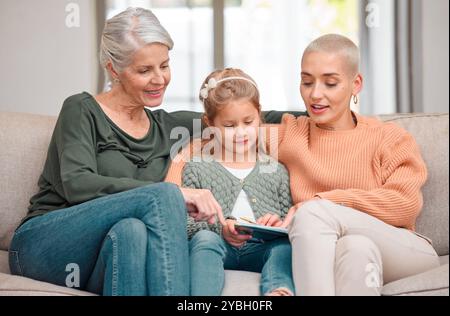 House, grandmother and girl with tablet, mama and typing with smile, bonding together and relax in living room. Family, granny and daughter with tech Stock Photo