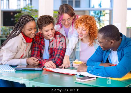 Diverse group of students collaborating at table Stock Photo