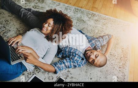 Happy, relaxed and carefree couple bonding together on the living room floor at home. Loving, affectionate and smiling boyfriend and girlfriend Stock Photo