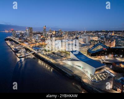 Liverpool waterfront from above at night, showing the illuminated Pier Head and city skyline beside the River Mersey. Stock Photo