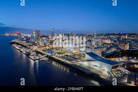 Liverpool waterfront from above at night, showing the illuminated Pier Head and city skyline beside the River Mersey. Stock Photo