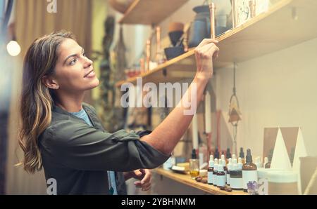 Female person, inventory and products in retail store as small business owner for fragrance or serum. Woman, quality control and logistics in online Stock Photo