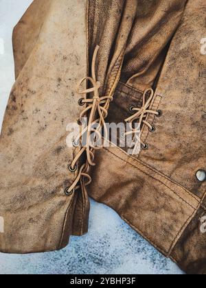 Vintage brown leather jacket, grunge cropped distressed jacket, leatherjacket bolero, lace up leather jacket 80s 90s, vintage woman's clothes, retro style apparel Stock Photo