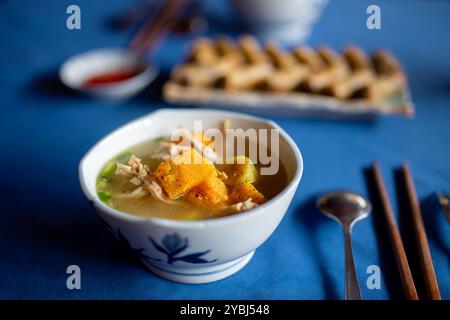 Selective focus on hot soup with chicken and pumpkin served in  bowl. Tasty food in Vietnam. Stock Photo