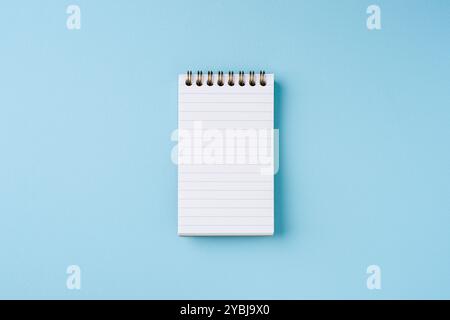 Top view of lined notebook on blue background Stock Photo