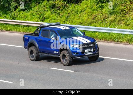 Blue White Ford Raptor Shelby Edition Ford Performance EcoBoost engine twin-turbo V-6 travelling on the M6 motorway UK Stock Photo