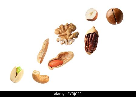 Macadamia and other nuts in air on white background Stock Photo