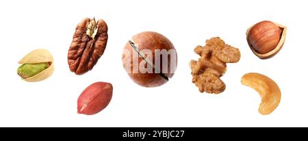 Macadamia and other nuts in air on white background Stock Photo