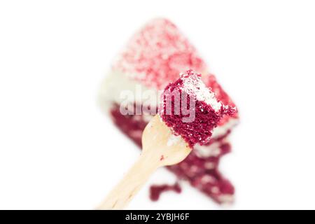 Closeup of red velvet cake on wooden spoon. Top view Stock Photo