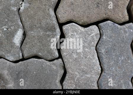 Close-up of gray interlocking paving stones with detailed texture. Stock Photo
