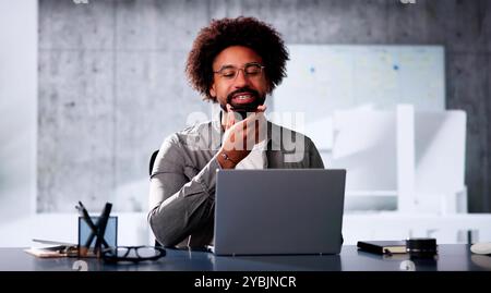African Man Using Mobile Phone For Voice Messaging Stock Photo