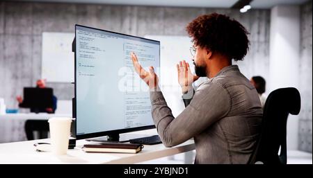 Unhappy Sad Developer Programmer Man In Stress Coding Software On Computer Stock Photo