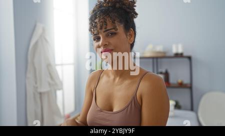 Young woman with curly hair in wellness spa salon room Stock Photo
