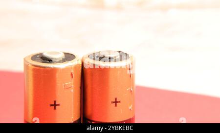 Close up of two AA batteries on pink and white background. Energy concepts Stock Photo