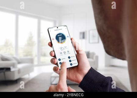 Controlling home heating temperature through a mobile app. Man adjusts the warmth with a slider for optimal comfort and energy efficiency Stock Photo