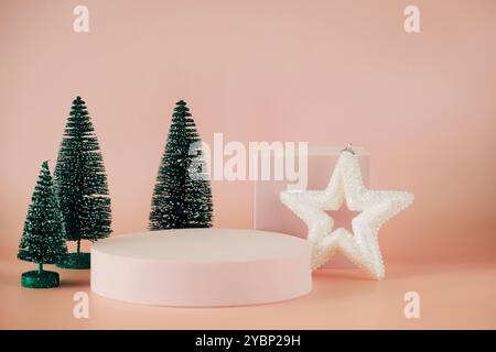 Empty geometric platform podiums for Christmas, New year product advertising. Blank platform stand on pale pink background with small Christmas trees Stock Photo