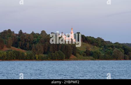 The church illuminated by the setting sun on the banks of the Volga River Stock Photo