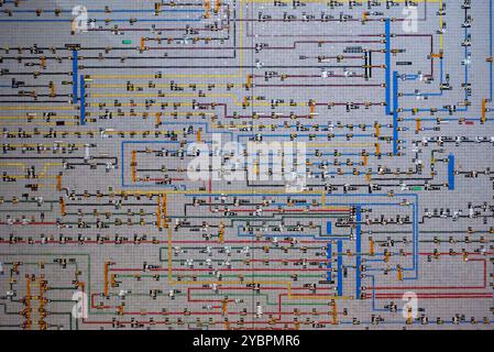 Intricate network diagram displaying multiple interconnected lines and elements on a grid, capturing the complexity and organization of an industrial Stock Photo