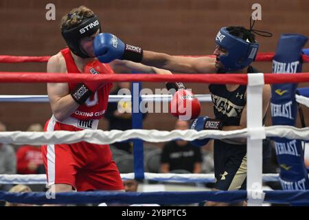 Columbus, Ohio, United States. 19th October, 2024. Malek Ghodhbani of the US Naval Academy punches Aidan Poling of The Ohio State University in the Men's 172lb category at the Buckeye Brawl 2024 in Columbus, Ohio, USA. Credit: Brent Clark/Alamy Live News Stock Photo