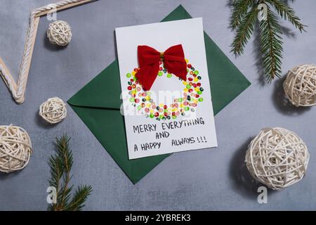 Christmas wreath Craft Christmas greeting card holiday present. Tactile hand-on activity. Creative me-made gifts. Seasonal domestic life micro moment hobby. Sustainable living Stock Photo