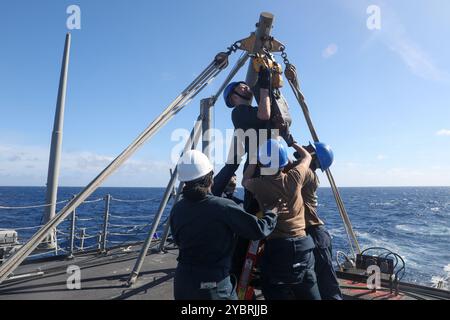 241018-N-CV021-1054 SOUTH CHINA SEA (Oct. 18, 2024) Sailors aboard the Arleigh Burke-class guided-missile destroyer USS Howard (DDG 83) conduct a torpedo download in the South China Sea, Oct. 18. Howard is forward-deployed and assigned to Destroyer Squadron (DESRON) 15, the Navy’s largest DESRON and the U.S. 7th Fleet’s principal surface force. (U.S. Navy photo by Mass Communication Specialist 3rd Class Alexandria Esteban) Stock Photo