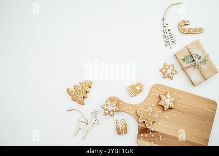 Homemade ginger cookies on wooden board with tree decoration. Christmas cookie, winter holidays Stock Photo