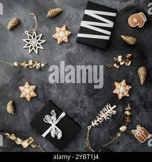 Holiday concept with Christmas gifts, cookies and golden decoration on dark background. Stock Photo