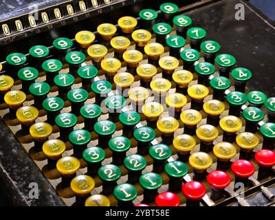 An old fashioned adding machine features a drawer located underneath it Stock Photo
