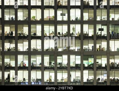 Modern office at night, showing the daily activity of office workers Stock Photo