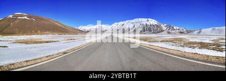 The panoramic road that crosses the plateau of Castelluccio di Norcia in Umbria Italy in the winter season Stock Photo