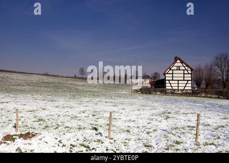 Timber framed house in a snow covered landscape in the Dutch hamlet Terziet near Epen Stock Photo